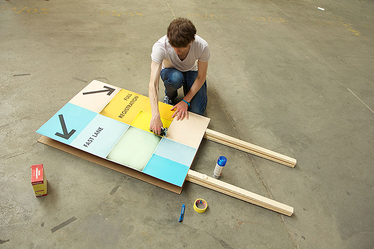 Johannes building a sign.